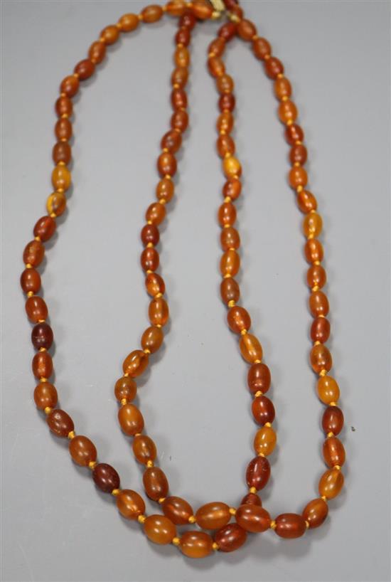 A double strand oval amber bead necklace, 66cm, gross 58 grams.